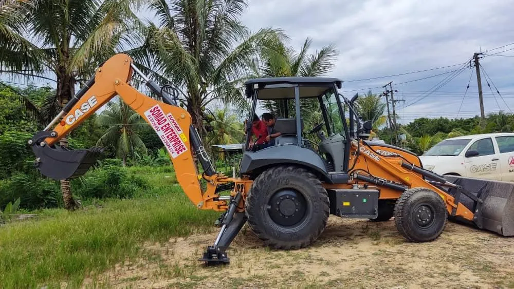Company-operated backhoe loader on site
